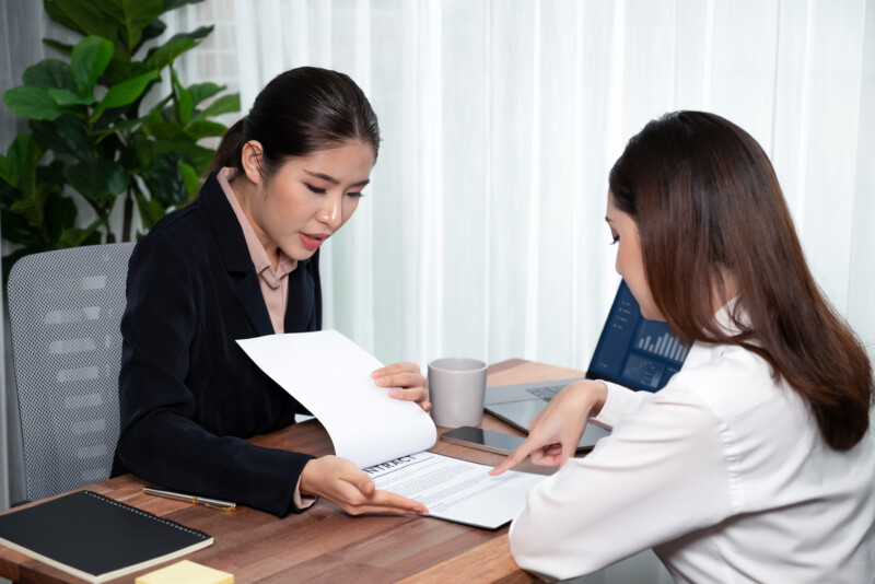 business deal meeting businesswomen reviewing terms condition equilibrium