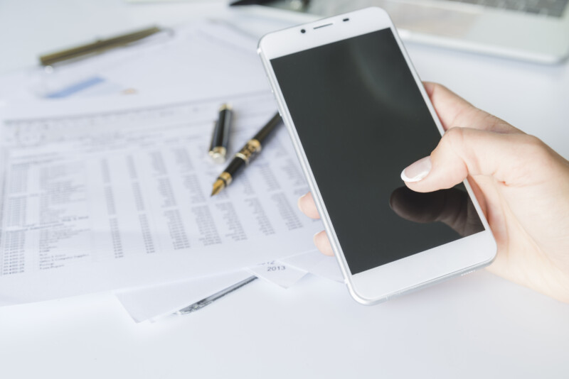 hand holding smartphone workplace